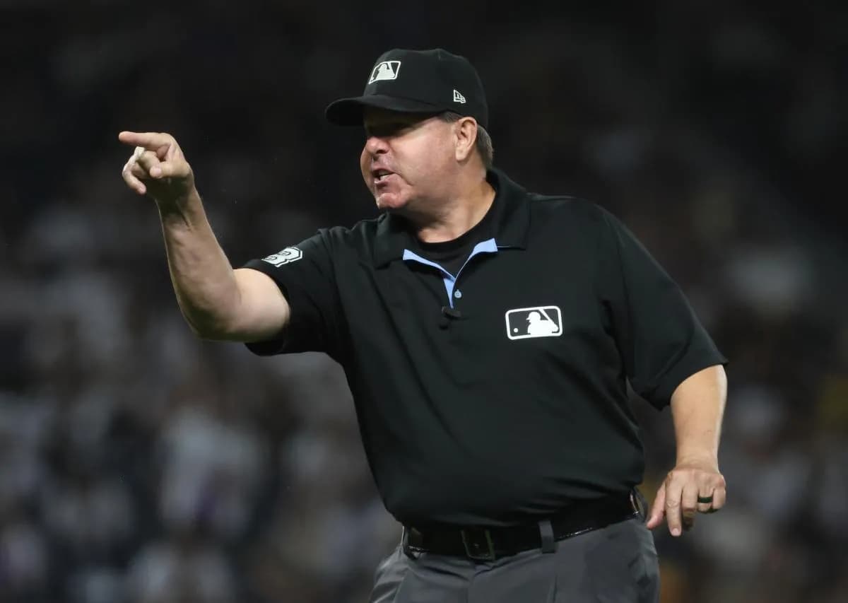 MLB umpire Doug Eddings (88) gestures to the Athletics dugout against the Pittsburgh Pirates during the fifth inning at PNC Park.