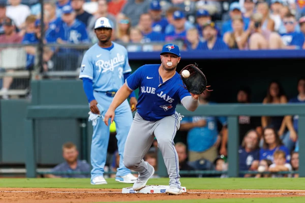 Toronto Blue Jays first base Ty France (2) reaches for a throw to first base during the second inning against the Kansas City Royals at Kauffman Stadium.