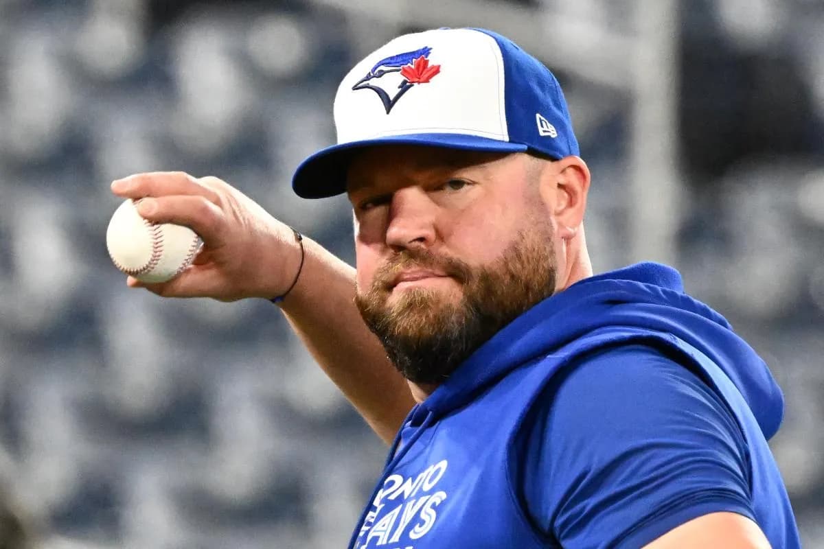 Toronto Blue Jays manager John Schneider (14) throws the ball during workouts for the American League Championship Series at Rogers Centre.