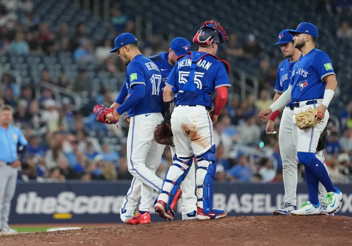 Toronto Blue Jays starting pitcher Jose Berrios (17) is relieved by manager John Schneider (14) against the Tampa Bay Rays during the sixth inning at Rogers Centre.