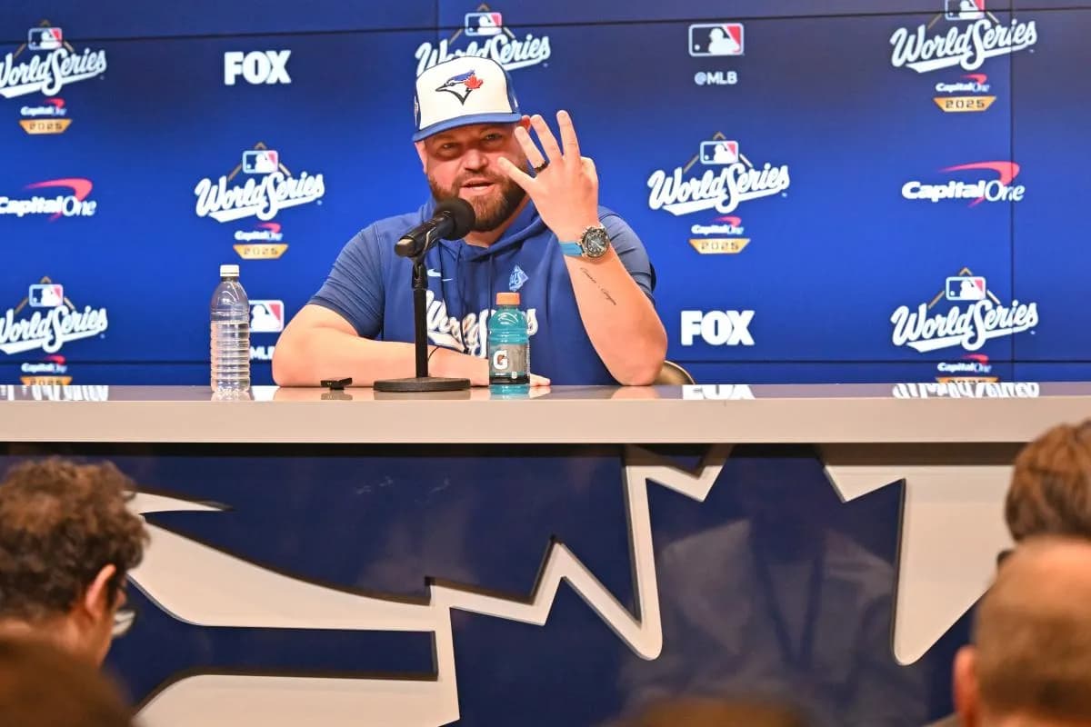 Toronto Blue Jays manager John Schneider (14) speaks to the media during media day and team workouts at Rogers Centre.