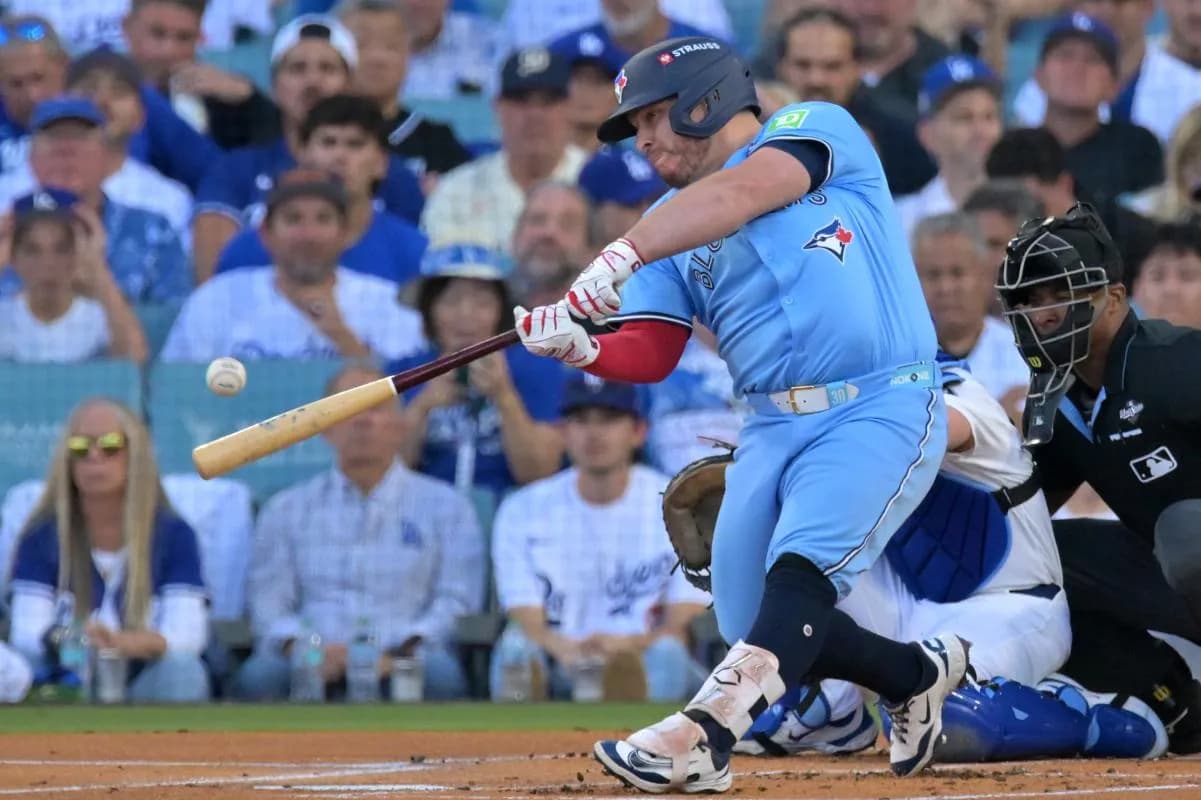 Toronto Blue Jays catcher Alejandro Kirk (30) hits a single against the Los Angeles Dodgers in the first inning during game five of the 2025 MLB World Series at Dodger Stadium.