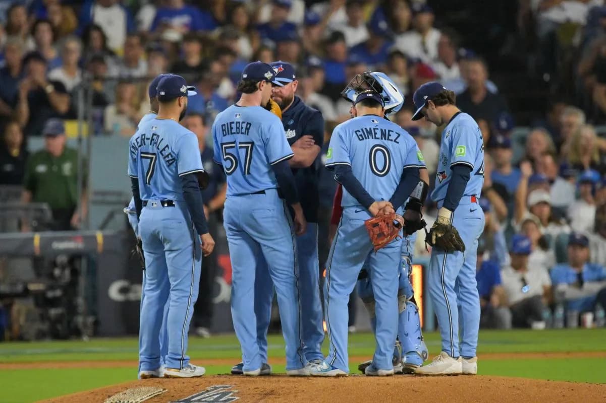 Toronto Blue Jays manager John Schneider (14) pulls Toronto Blue Jays pitcher Shane Bieber (57) from the game during the sixth inning against the Los Angeles Dodgers during game four of the 2025 MLB World Series at Dodger Stadium.