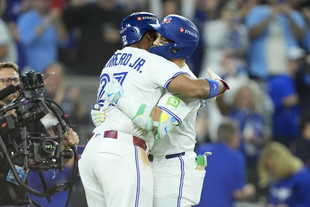 Toronto Blue Jays designated hitter Bo Bichette (11) celebrates with first baseman Vladimir Guerrero Jr. (27) after hitting a three run home run against the Los Angeles Dodgers in the third inning during game seven of the 2025 MLB World Series at Rogers Centre.