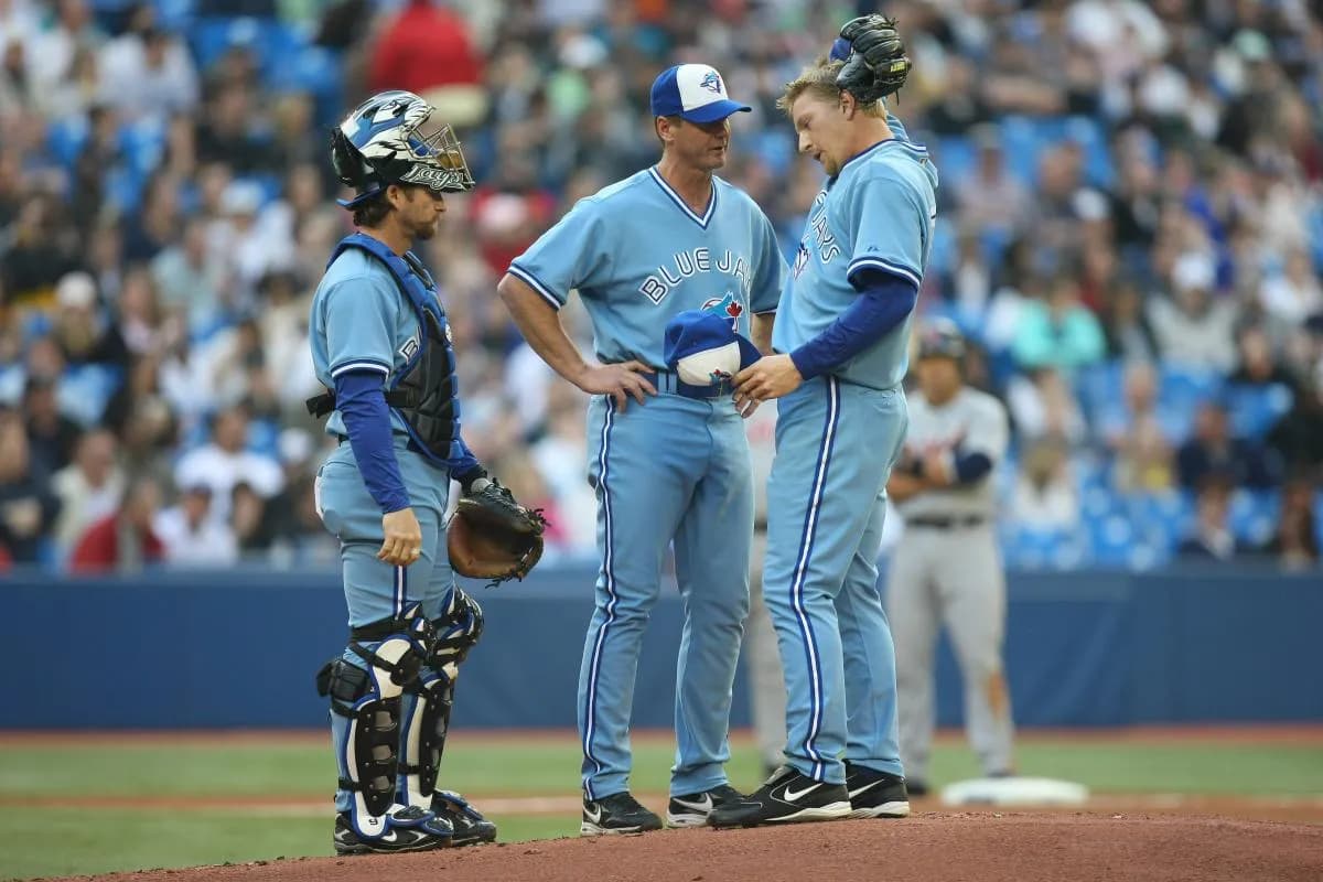 Toronto Blue Jays starting pitcher David Purcey (25) gets a visit to the mound from picthing coach Brad Arnsberg (38) and catcher Gregg Zaun (9) against the Detroit Tigers at the Rogers Centre in Toronto, ON.