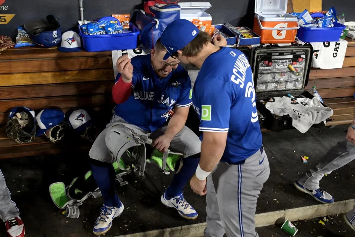 Toronto Blue Jays catcher Alejandro Kirk (30) celebrates with left fielder Davis Schneider (36) in the dugout after hitting a three run home run against the Los Angeles Dodgers in the fourth inning during game three of the 2025 MLB World Series at Dodger Stadium.
