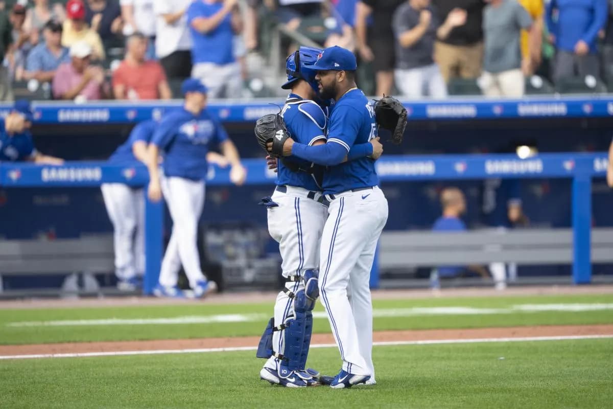 Toronto Blue Jays catcher Reese McGuire (7) and Toronto Blue Jays pitcher Joel Payamps (54) embrace to celebrate the victory after the ninth inning at Sahlen Field.