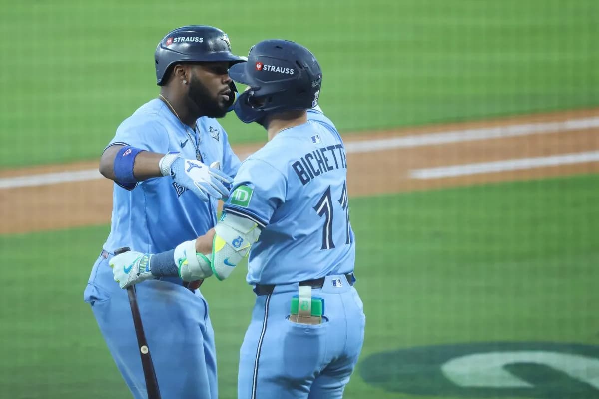 Toronto Blue Jays first baseman Vladimir Guerrero Jr. (27) celebrates with Toronto Blue Jays designated hitter Bo Bichette (11) after hitting a two run home run during the third inning against the Los Angeles Dodgers during game four of the 2025 MLB World Series at Dodger Stadium.