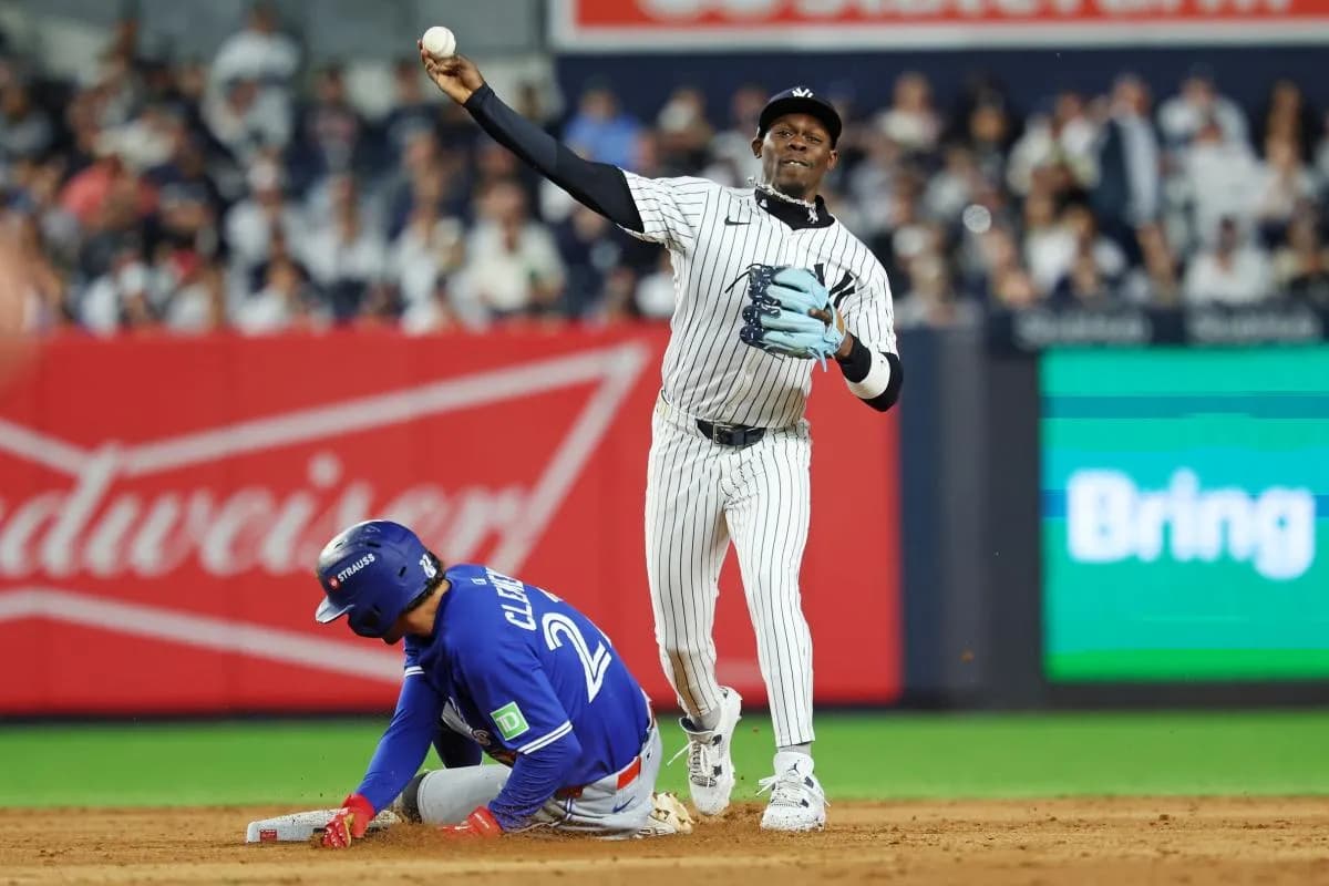 New York Yankees second baseman Jazz Chisholm Jr. (13) forces out Toronto Blue Jays third baseman Ernie Clement (22) and tries to turn a double play during the eighth inning during game four of the ALDS round for the 2025 MLB playoffs at Yankee Stadium.