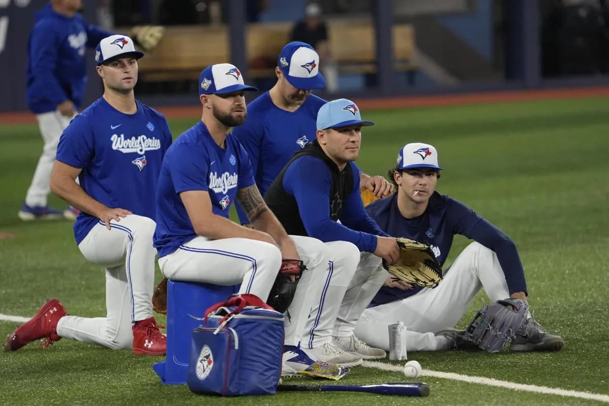 Toronto Blue Jays right fielder Nathan Lukes (left) and center fielder Daulton Varsho (center) and outfielder Joey Loperfido (right) wait for batting pratice on media day before game one of the World Series at Rogers Centre.
