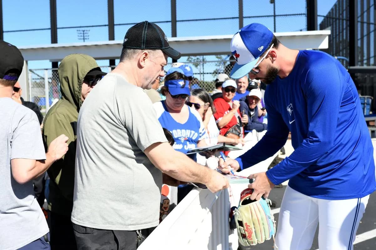 Toronto Blue Jays pitcher Adam Kloffenstein signs autographs during spring training at Cecil B. Englebert Complex.