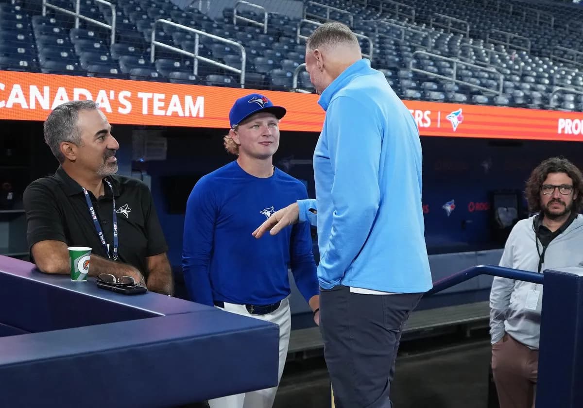 Toronto Blue Jays first round draft pick JoJo Parker talks to president and CEO Mark Shapiro during batting practice before a game against the Baltimore Orioles at Rogers Centre.