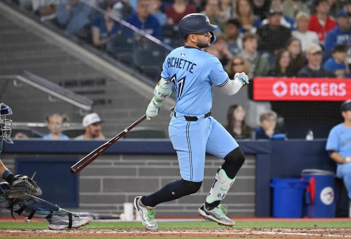 Toronto Blue Jays shortstop Bo Bichette (11) hits an RBI single against the Seattle Mariners in the third inning at Rogers Centre.