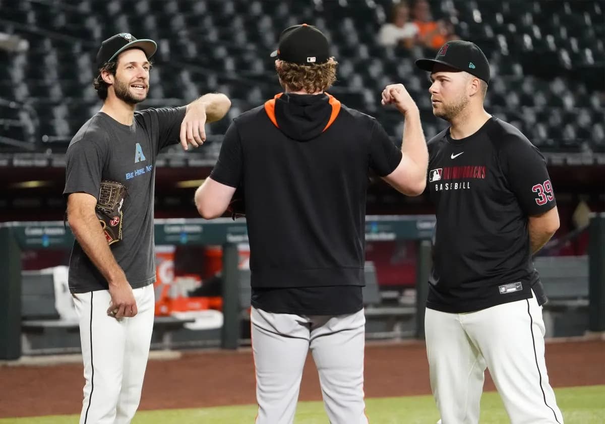 Arizona Diamondbacks pitchers Zac Gallen and Corbin Burnes chat with San Francisco Giants pitcher Logan Webb (center) before their game at Chase Field on Sept. 17, 2025.