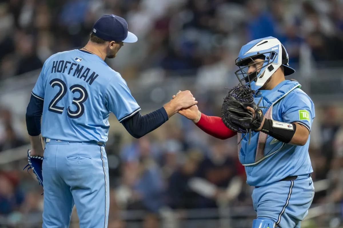 Toronto Blue Jays relief pitcher Jeff Hoffman (23) and catcher Alejandro Kirk (30) after defeating the Minnesota Twins at Target Field.