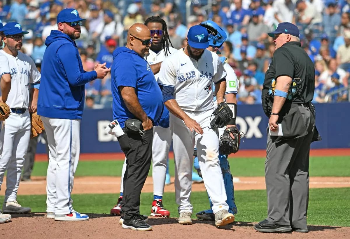 Toronto Blue Jays relief pitcher Yimi Garcia (93) is relieved by Toronto Blue Jays manager John Schneider (14) in the ninth inning against the Cleveland Guardians at Rogers Centre