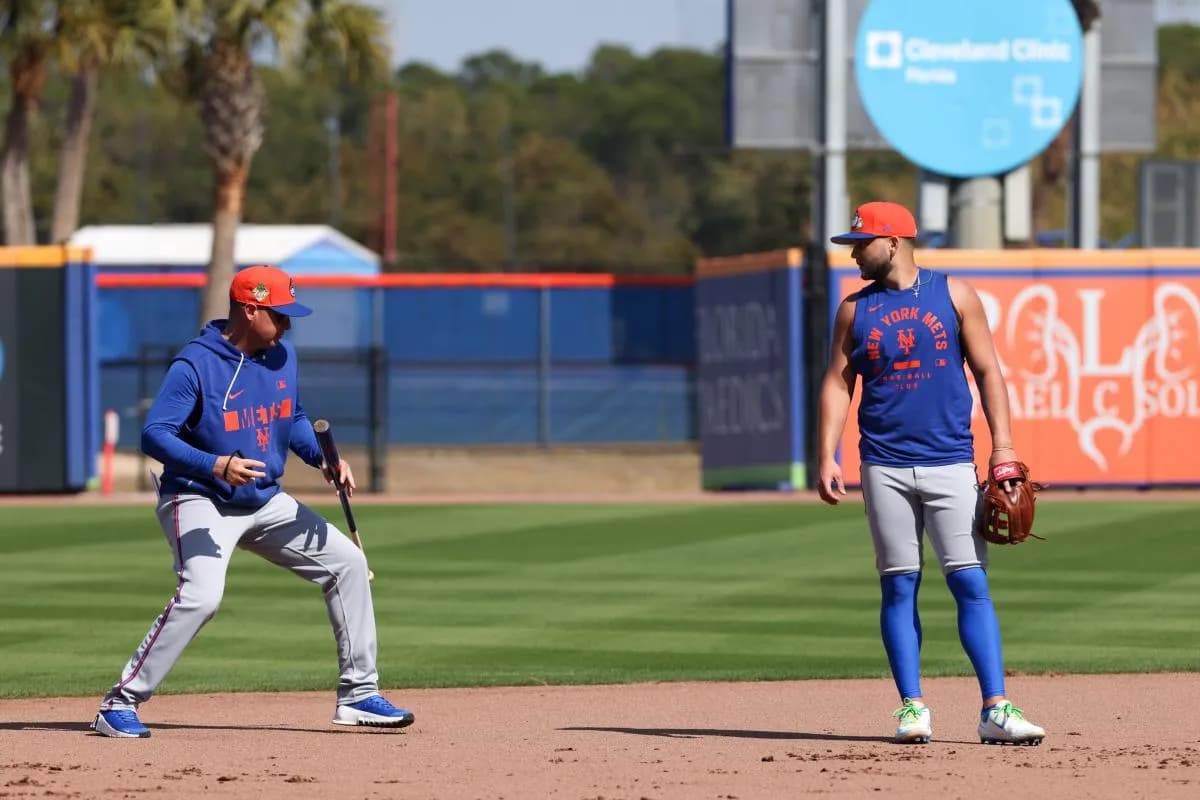 New York Mets shortstop Bo Bichette (19) works with manager Carlos Mendoza (64) during spring training at Clover Park.