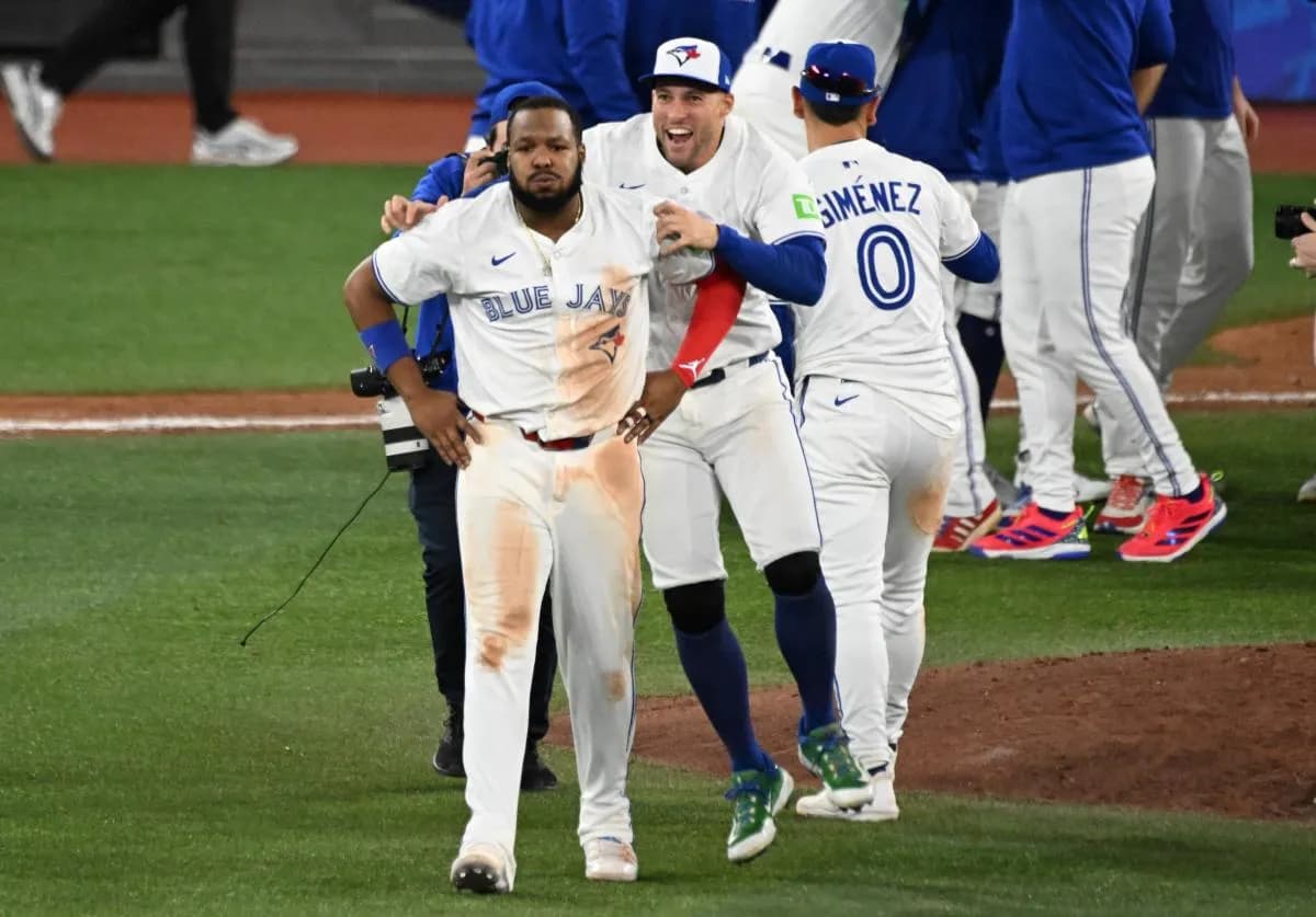 Toronto Blue Jays first baseman Vladimir Guerrero Jr. (27) and designated hitter George Springer (4) celebrate after winning game seven of the ALCS round for the 2025 MLB playoffs against the Seattle Mariners at Rogers Centre.