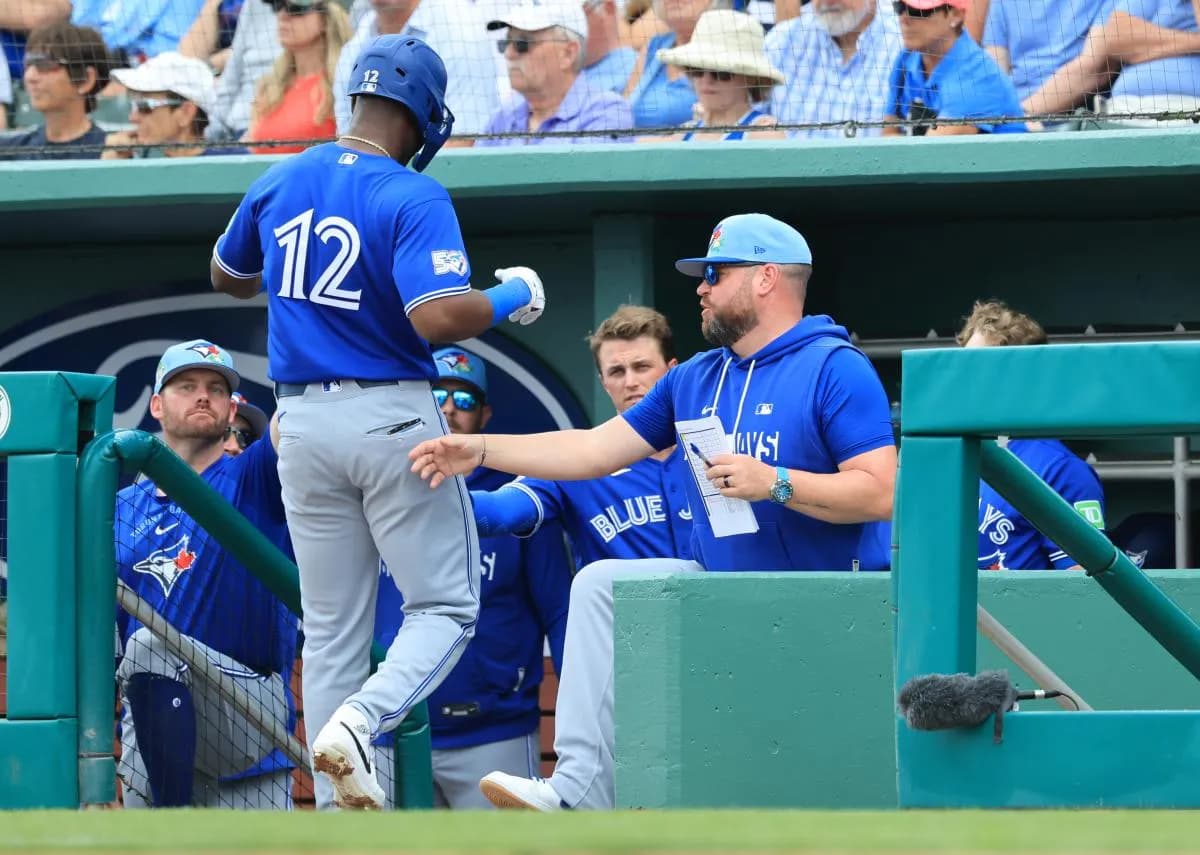 Toronto Blue Jays right fielder Jesus Sanchez (12) is congratulated by manager John Schneider (14) after he scored a run against the Boston Red Sox at JetBlue Park at Fenway South