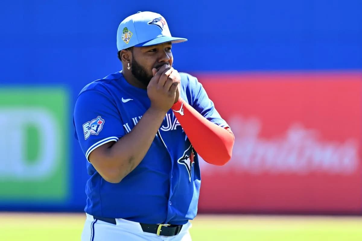 Toronto Blue Jays first baseman Vladimir Guerrero Jr. (27) warms his hands before a spring training game against the New York Mets at TD Ballpark.