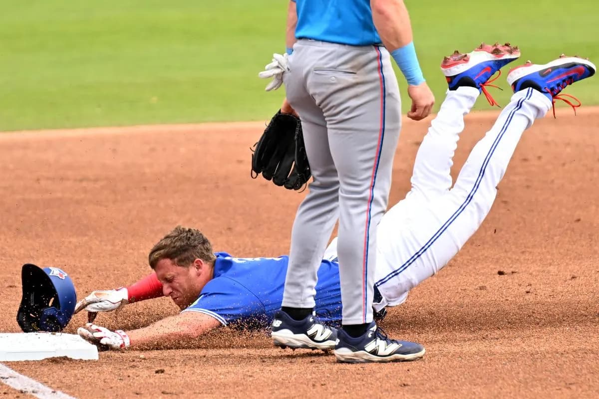 Toronto Blue Jays left fielder Myles Straw (3) slides into third base in the second inning against the Florida Marlins during spring training at TD Ballpark.