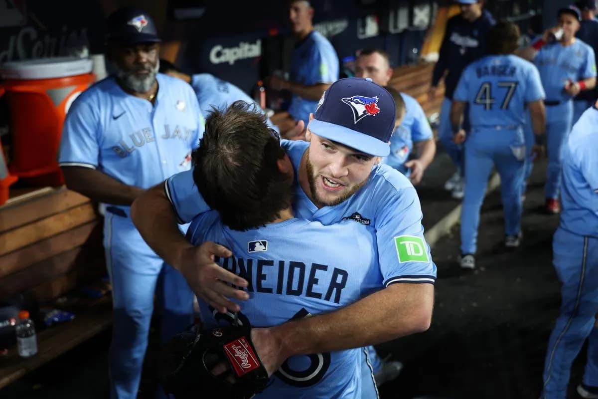 Toronto Blue Jays pitcher Trey Yesavage (39) celebrates with Toronto Blue Jays left fielder Davis Schneider (36) in the dugout after the game against the Los Angeles Dodgers during game five of the 2025 MLB World Series at Dodger Stadium.