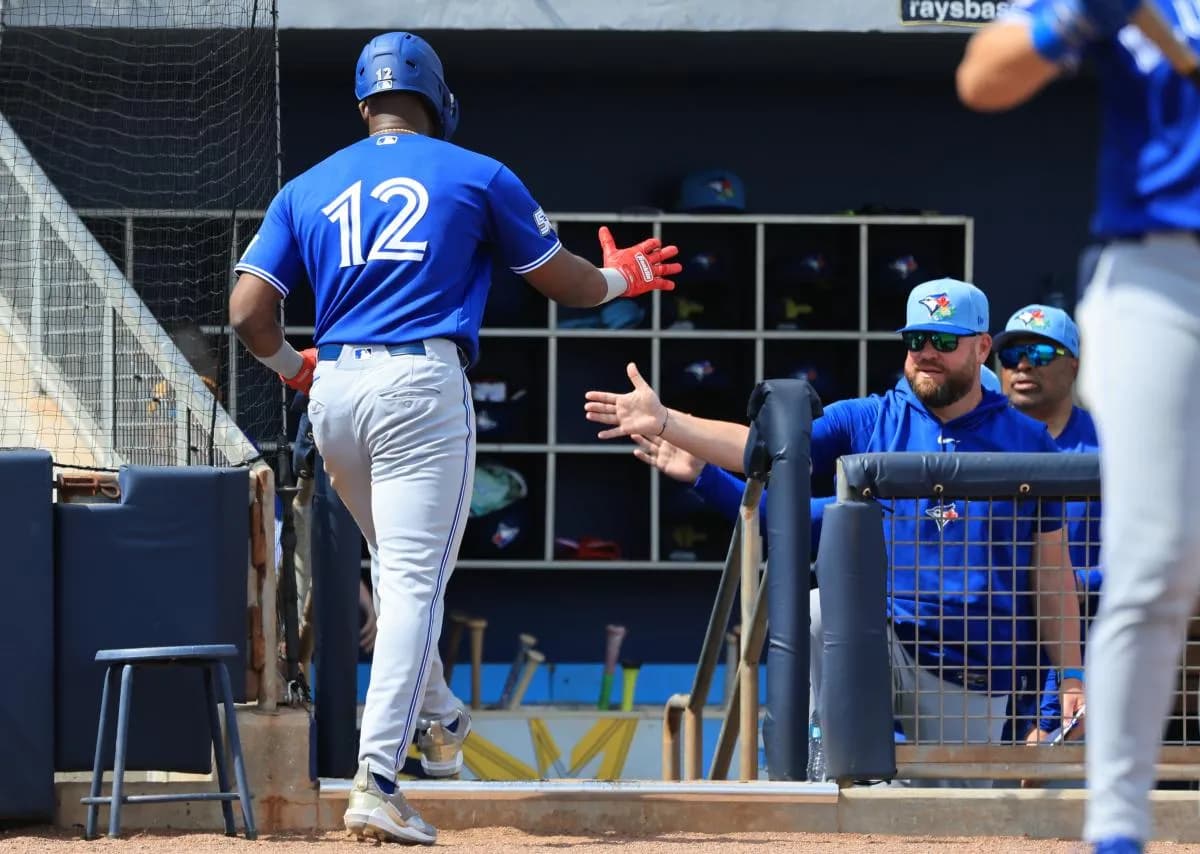 Toronto Blue Jays right fielder Jesus Sanchez (12) is congratulated by manager John Schneider (14) after he scored during the second inning against the Tampa Bay Rays at Charlotte Sports Park.