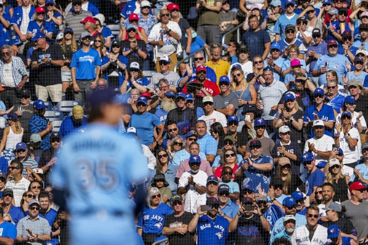 Toronto Blue Jays fans stand up during the ninth inning before pitcher Ryan Borucki (35) sets to pitch to the Baltimore Orioles at Rogers Centre.