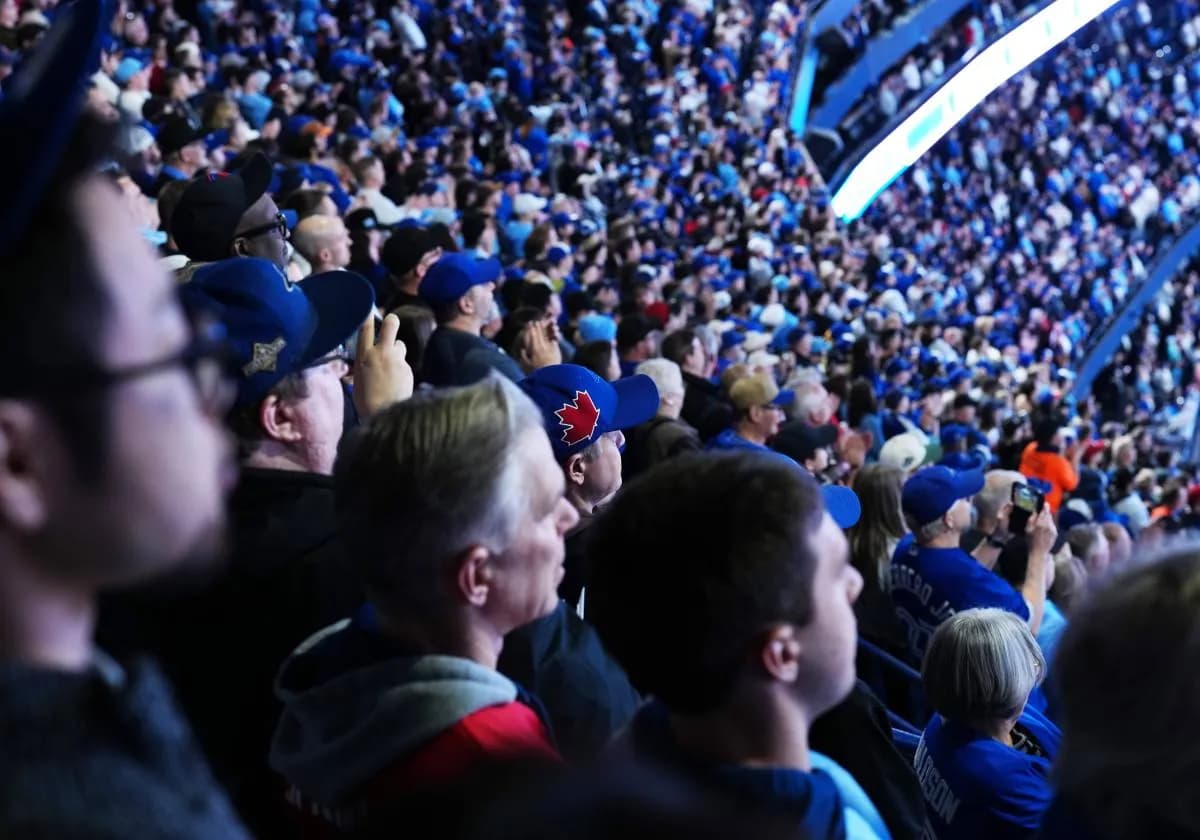 Fans watch the opening ceremonies before a game between the Athletics and the Toronto Blue Jays at Rogers Centre.