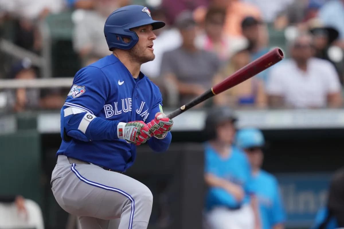 Toronto Blue Jays center fielder Daulton Varsho (5) hits a double that scores two runs in the third inning against the Miami Marlins at Roger Dean Chevrolet Stadium.