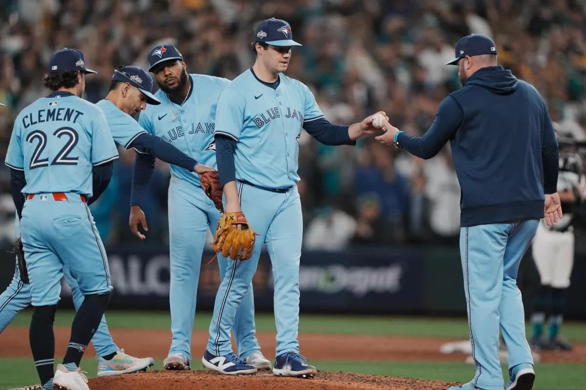 Toronto Blue Jays manager John Schneider (14) takes the ball from pitcher Brendon Little (54) in the eighth inning during game five of the ALCS round against the Seattle Mariners for the 2025 MLB playoffs at T-Mobile Park.