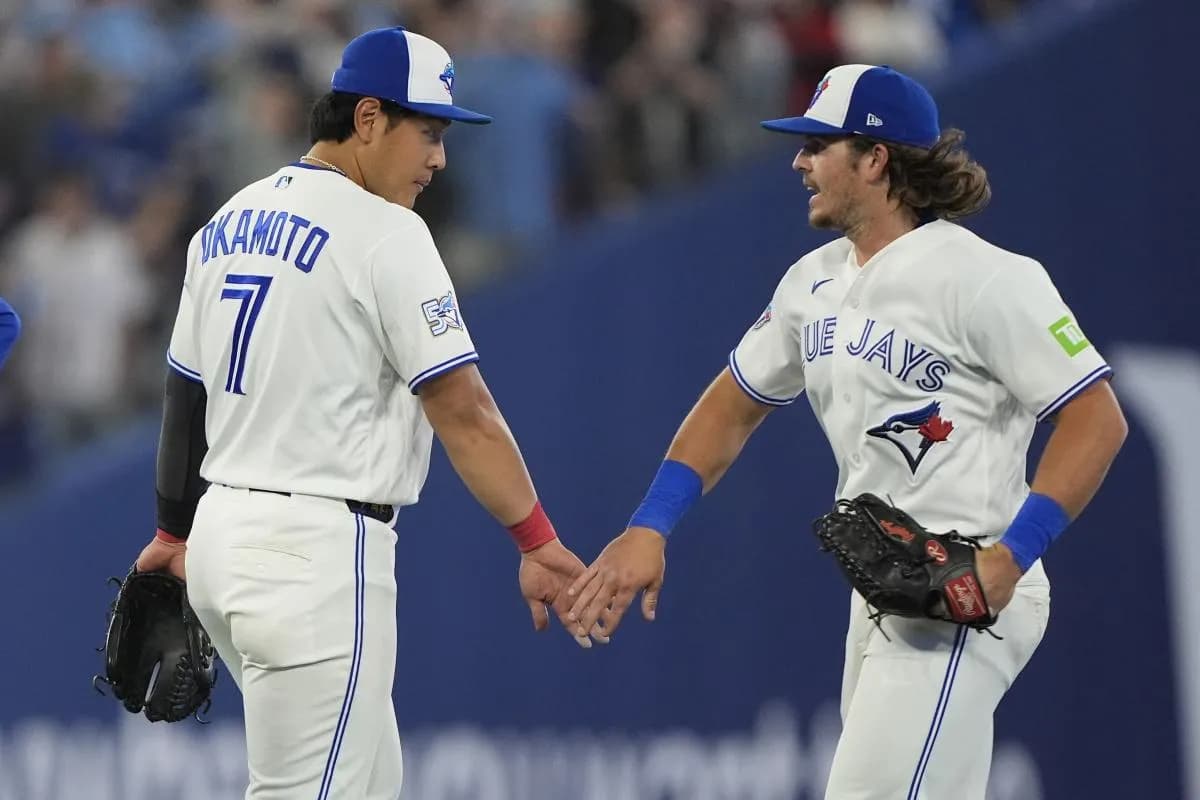 Toronto Blue Jays third baseman Kazuma Okamoto (7) and right fielder Addison Barger (47) celebrate a win over the Athletics at Rogers Centre.