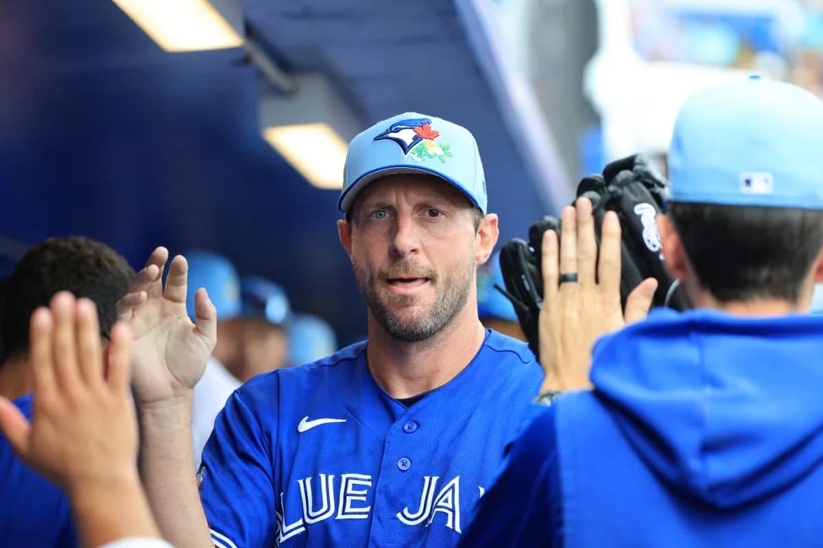 Toronto Blue Jays starting pitcher Max Scherzer (31) is congratulated in the dugout after he pitched against the Toronto Blue Jays at TD Ballpark.