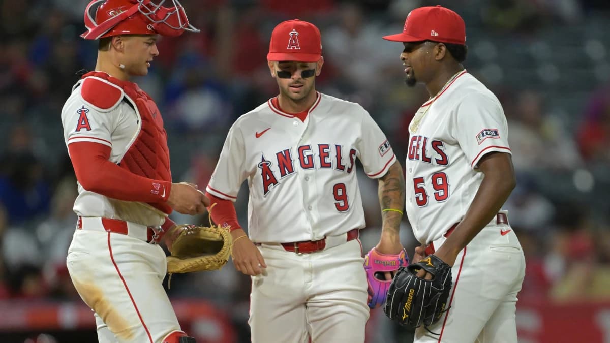 Los Angeles Angels catcher Logan O'Hoppe (14) and shortstop Zach Neto (9) meet at the mound with starting pitcher Jose Soriano (59) during the seventh inning against the Atlanta Braves at Angel Stadium.