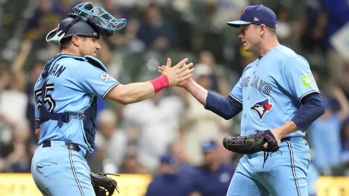 Toronto Blue Jays catcher Tyler Heineman (55) greets pitcher Louis Varland (77) following the game against the Milwaukee Brewers at American Family Field.
