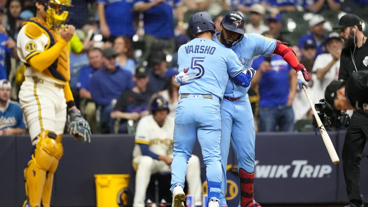 Toronto Blue Jays center fielder Daulton Varsho (5) celebrates with first baseman Vladimir Guerrero Jr. (27) after hitting a home run during the sixth inning against the Milwaukee Brewers at American Family Field.