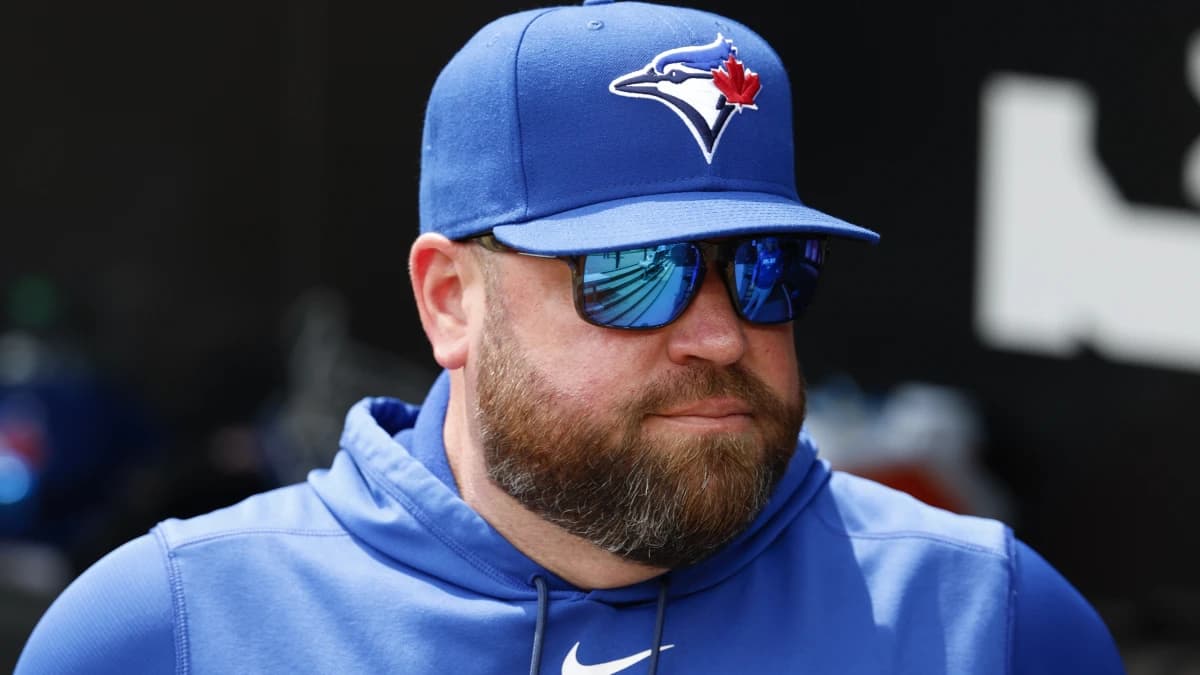 Toronto Blue Jays manager John Schneider looks on from the dugout before a baseball game against the Chicago White Sox at Rate Field.