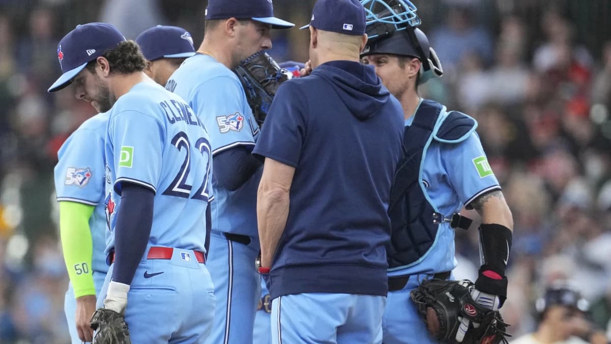 /41/ talks with Toronto Blue Jays pitcher Patrick Corbin (46) and Toronto Blue Jays catcher Tyler Heineman (55) in the fourth inning against there Milwaukee Brewers at American Family Field.