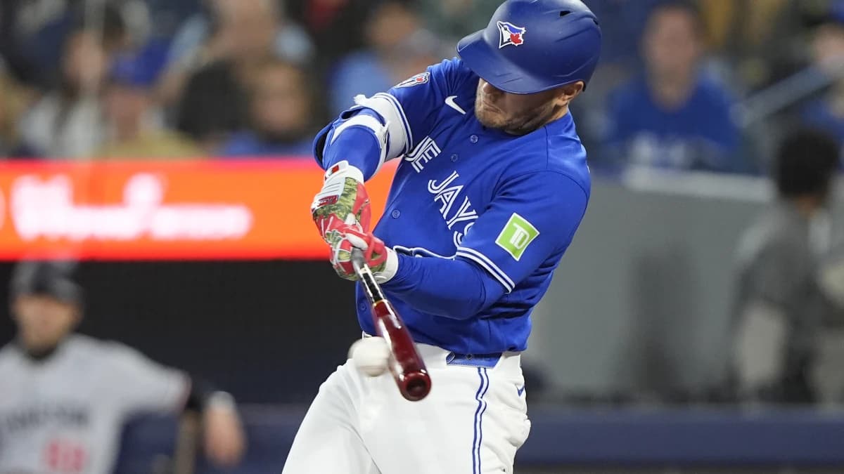 Toronto Blue Jays center fielder Daulton Varsho (5) hits a one run single against the Minnesota Twins during the first inning at Rogers Centre.