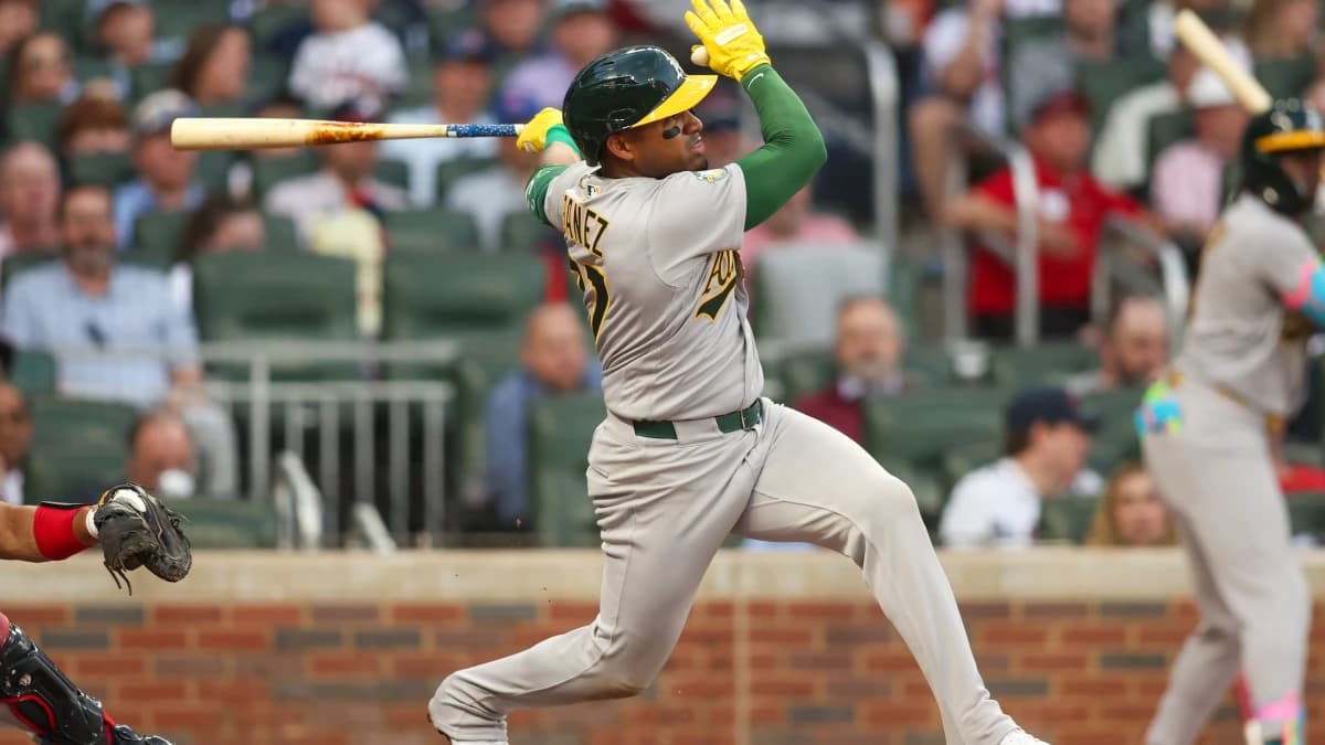 Athletics third baseman Andy Ibanez (77) hits an RBI single against the Atlanta Braves in the second inning at Truist Park.