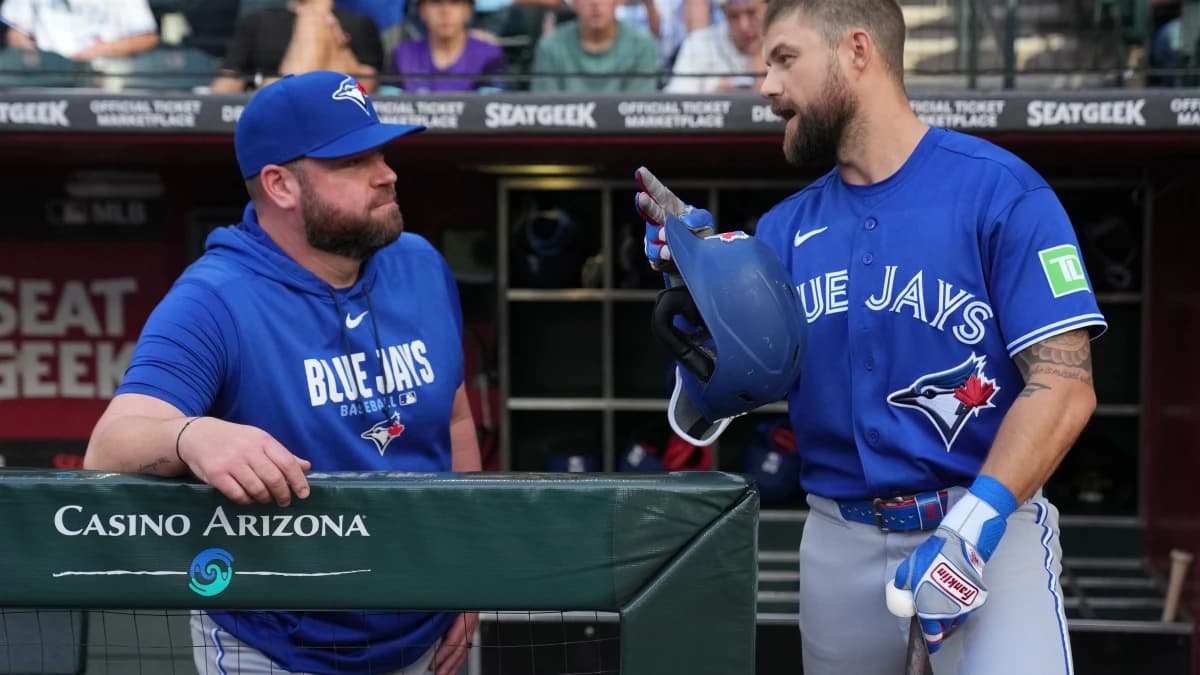 Toronto Blue Jays manager John Schneider (14) talks to right fielder Nathan Lukes (38) against the Arizona Diamondbacks in the first inning at Chase Field.