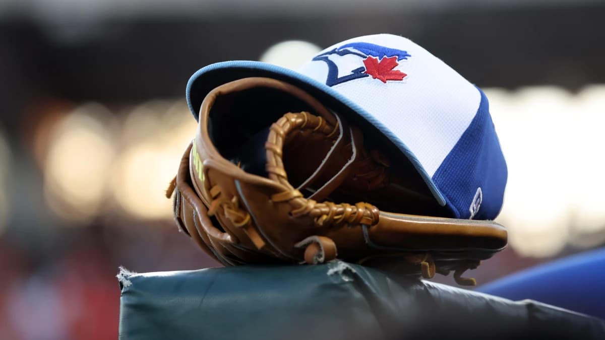 A detail view of a Toronto Blue Jays hat and glove against the Baltimore Orioles at Ed Smith Stadium