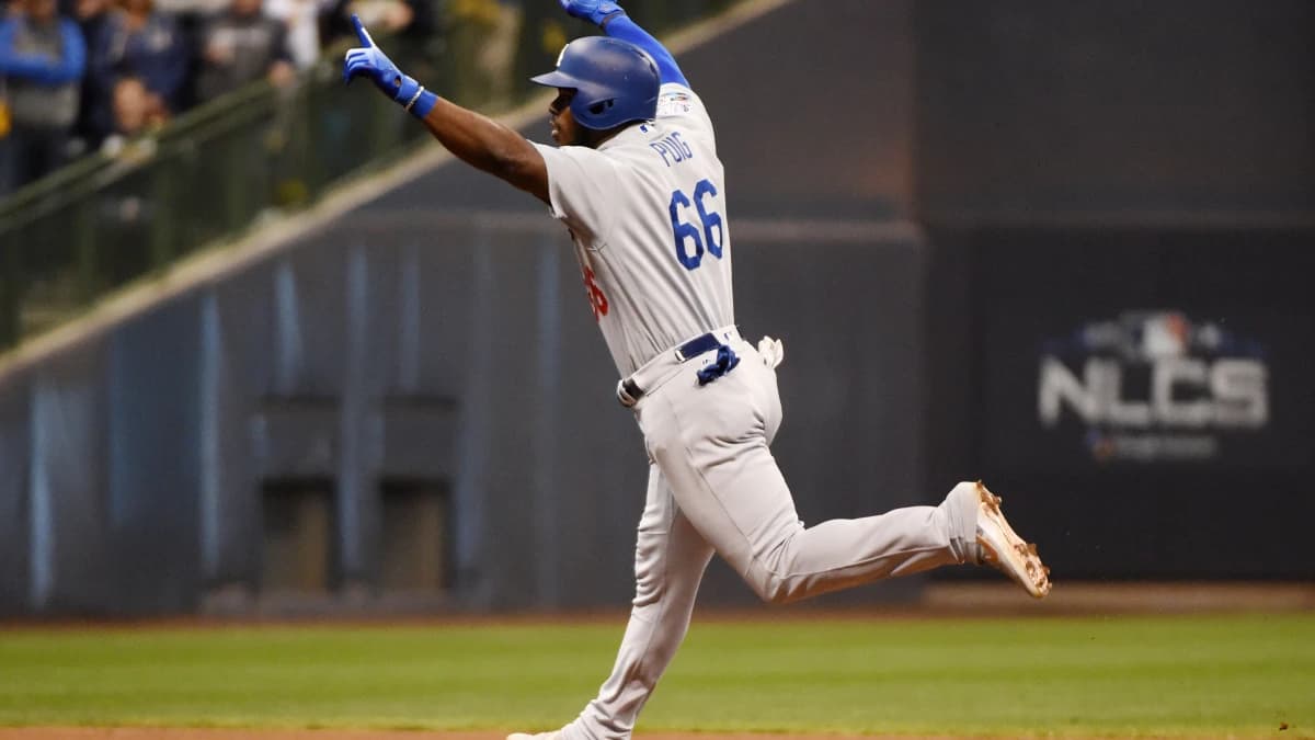 Los Angeles Dodgers outfielder Yasiel Puig (66) celebrates after hitting a three-run home run against the Milwaukee Brewers in the sixth inning in game seven of the 2018 NLCS playoff baseball series at Miller Park.