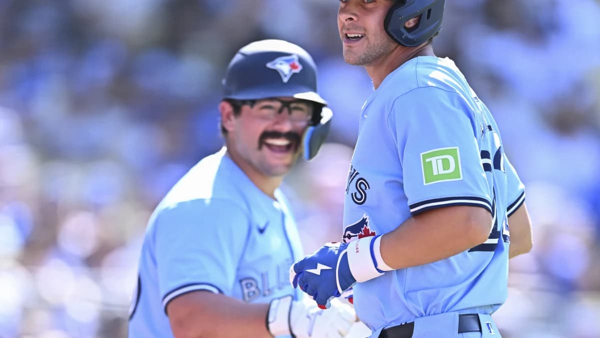 Toronto Blue Jays second baseman Ernie Clement (22) celebrates with outfielder Davis Schneider (36) after hitting a solo home run against the Los Angeles Dodgers during the ninth inning at Dodger Stadium. M