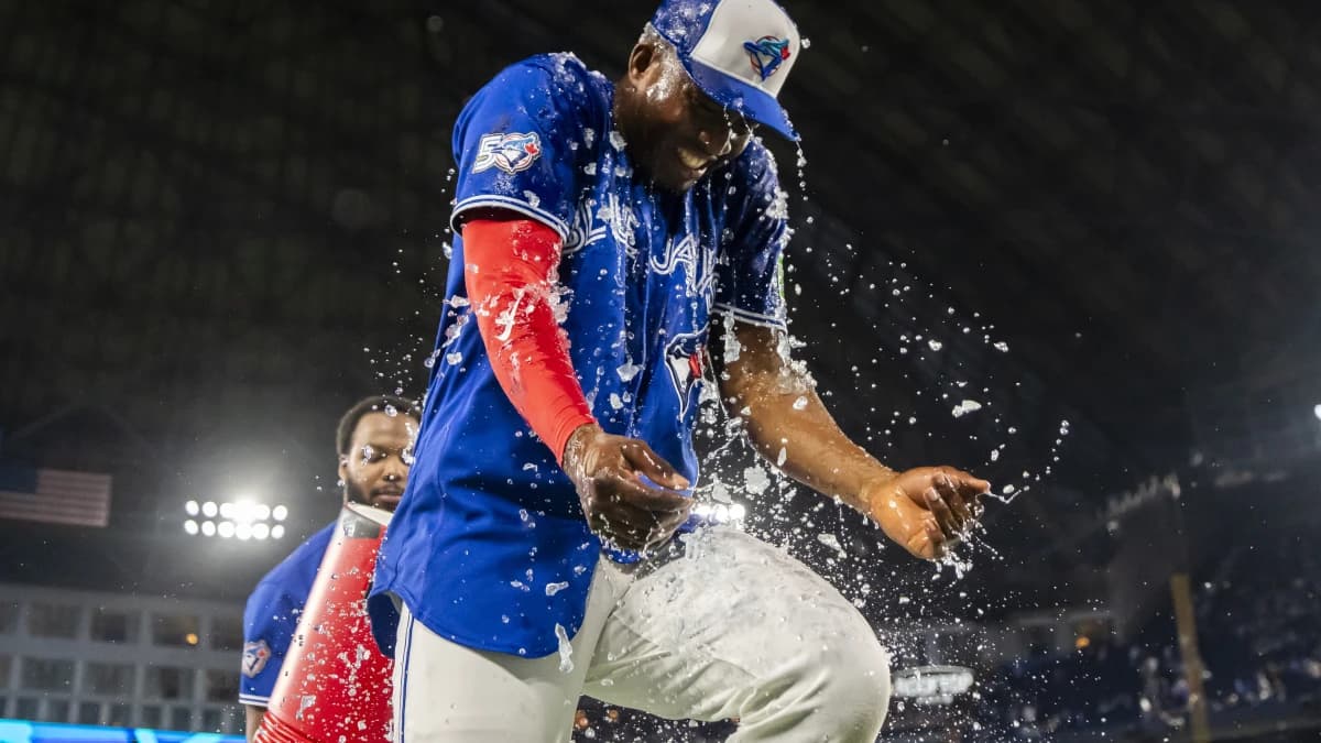 Toronto Blue Jays right fielder Jesús Sánchez (12) gets BodyArmor dumped by baseman Vladimir Guerrero Jr. (27) after defeating the Cleveland Guardians at Rogers Centre.