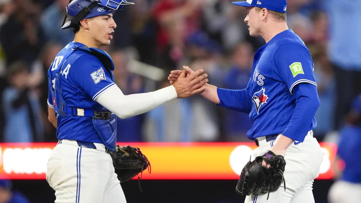 Toronto Blue Jays pitcher Louis Varland (77) and catcher Brandon Valenzuela (59) celebrate after defeating the Cleveland Guardians at Rogers Centre.