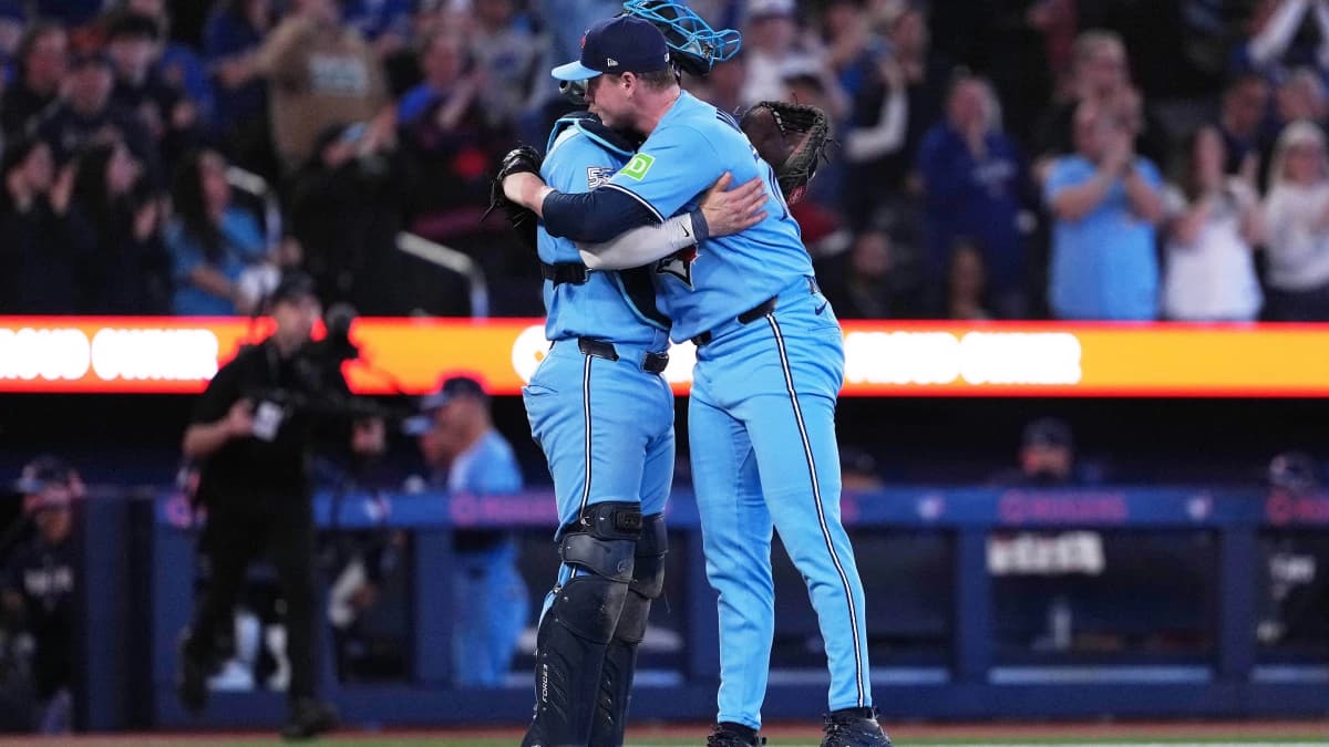 Toronto Blue Jays catcher Tyler Heineman (55) celebrates the win with relief pitcher Louis Varland (77) against the Boston Red Sox at the end of the ninth inning at Rogers Centre.