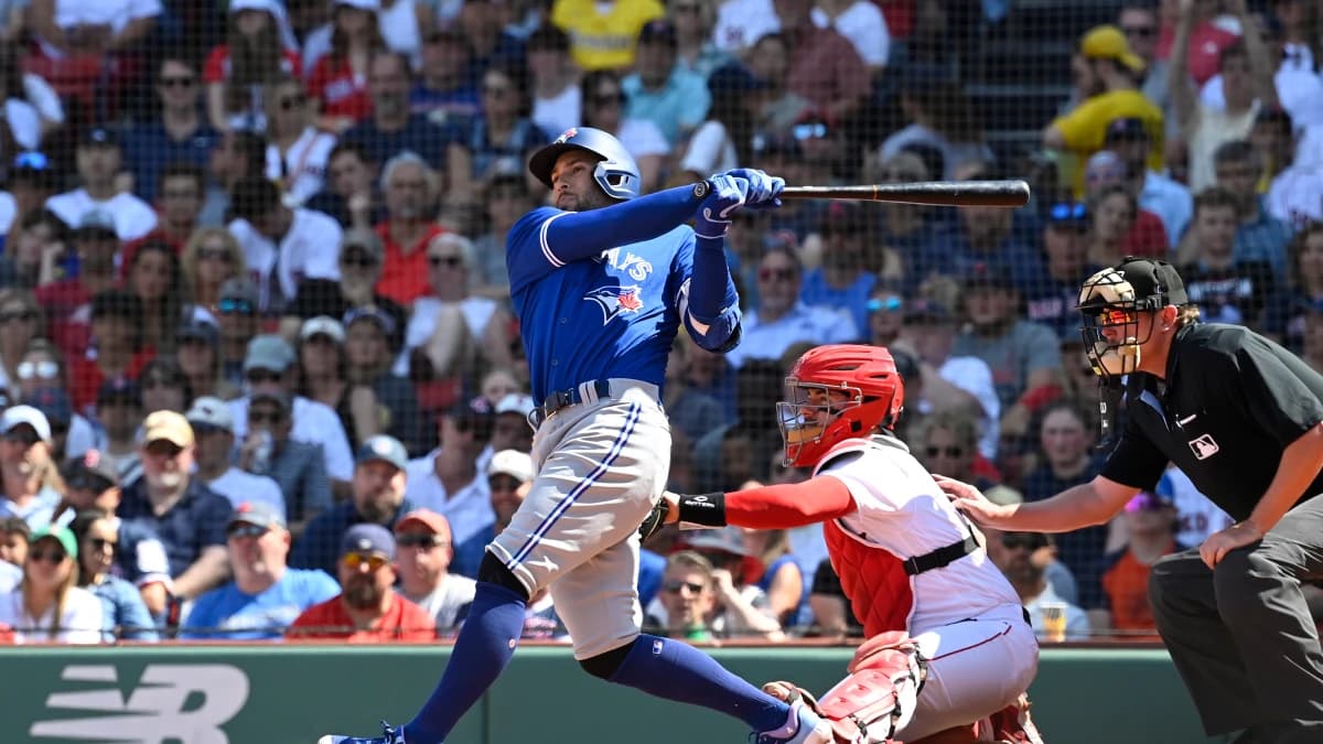 Toronto Blue Jays designated hitter George Springer (4) hits a sacrifice fly allowing shortstop Paul DeJong (10) to score against the Boston Red Sox during the fifth inning at Fenway Park.