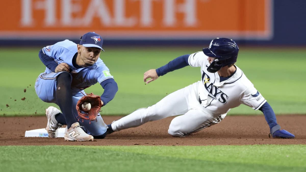 Tampa Bay Rays right fielder Jonny DeLuca (21) steals second base from Toronto Blue Jays shortstop Andres Gimenez (0) in the seventh inning at Tropicana Field.