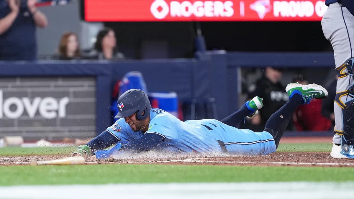 Toronto Blue Jays designated hitter George Springer (4) slides into home plate scoring a run against the Tampa Bay Rays during the seventh inning at Rogers Centre.